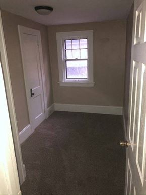 Akron house for rent - a small room with a window and a door
