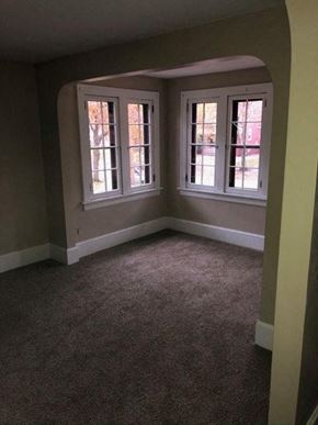 Akron house for rent - an empty room with three windows in it
