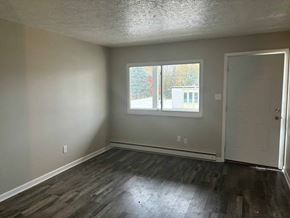 Akron apartment for rent - an empty living room with wood floors and a window