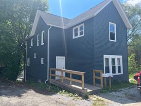 Akron apartment for rent - A blue house with a white door and windows.