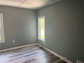 Akron apartment for rent - A room with a window and a wooden floor.