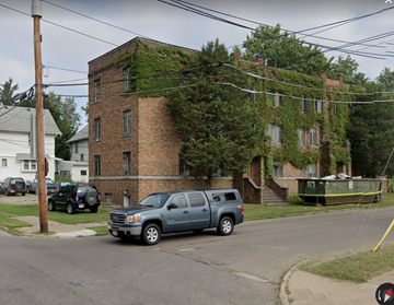 Akron apartment for rent - a truck parked in front of an old brick building