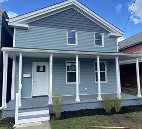 Cleveland house for rent - a blue house with white pillars and a white door