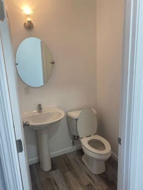 Cleveland house for rent - a bathroom with a toilet sink and a mirror