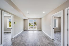 Washington apartment for rent - A spacious room with wood flooring and white walls.