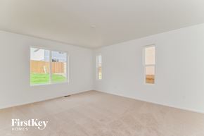 Colorado Springs house for rent - a spacious living room with white walls and a window