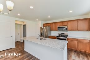 Colorado Springs house for rent - a kitchen with a marble counter top and wooden cabinets