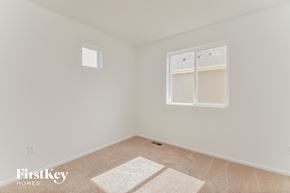 Colorado Springs house for rent - a bedroom with white walls and a window