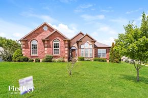 Platte City house for rent - a house on a hill with a green lawn