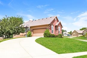 Platte City house for rent - a red brick house with a sidewalk in front of it