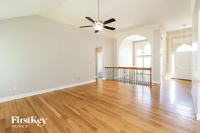 Platte City house for rent - a renovated living room with hardwood floors and a ceiling fan