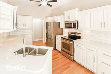 Platte City house for rent - a renovated kitchen with white cabinets and stainless steel appliances