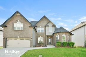 Clarksville house for rent - a brick house with a garage and a green lawn
