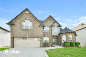 Clarksville house for rent - a large brick house with a white garage door