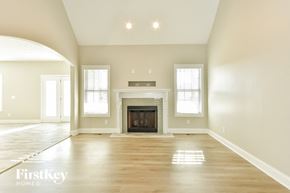 Clarksville house for rent - an empty living room with a fireplace