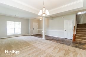 Winston-Salem house for rent - A spacious room with a staircase on the right side.