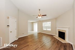 Sugar Hill house for rent - a living room with a fireplace and a ceiling fan