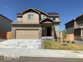 Colorado Springs house for rent - A house with a garage and a driveway in front of it.