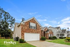Moncks Corner house for rent - A house with a garage and a brick chimney is for sale.