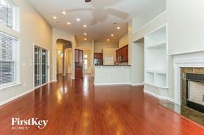 Moncks Corner house for rent - A spacious living room with wooden floors and a fireplace.