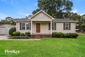 Kannapolis house for rent - A house with a brown door and a brick step in front.