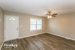 Kannapolis house for rent - A room with a white door and a ceiling fan.