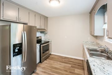 Kannapolis house for rent - A kitchen with a stainless steel refrigerator and wooden floors.