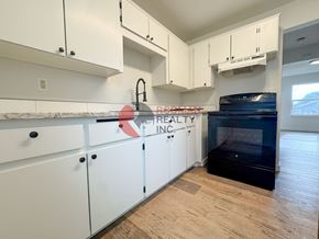 Longview apartment for rent - A kitchen with white cabinets and a black oven.