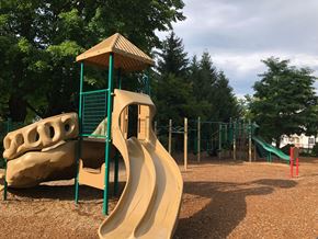 South Paris apartment for rent - A playground with a yellow slide and a green structure.