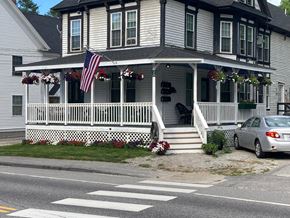 South Paris apartment for rent - A white house with a black roof and a car parked in front.