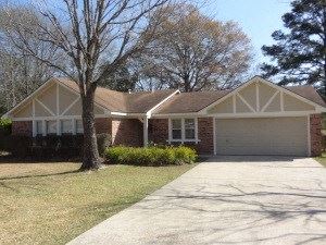 Deridder house for rent - A house with a white garage door and a brown roof.