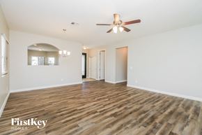 San Tan Valley house for rent - A spacious room with wooden flooring and a ceiling fan.
