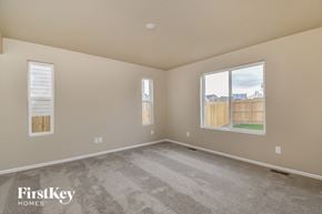 Colorado Springs house for rent - A room with a carpeted floor and two windows.