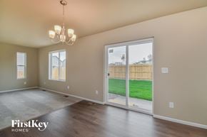 Colorado Springs house for rent - A room with a sliding glass door leading to a backyard.