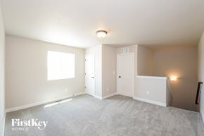 Colorado Springs house for rent - A spacious room with a carpeted floor and a window letting in natural light.