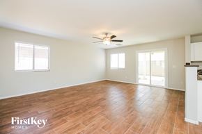 San Tan Valley house for rent - A spacious room with wooden flooring and a ceiling fan.