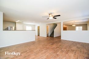 San Tan Valley house for rent - A spacious room with wooden flooring and a ceiling fan.