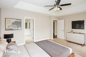 Midland house for rent - A bedroom with a bed, dresser, and ceiling fan.