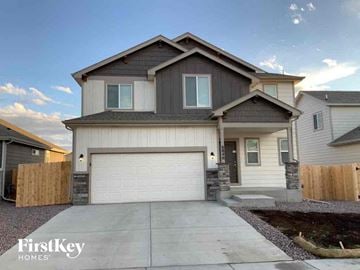 Colorado Springs house for rent - a house with a white garage door and a driveway
