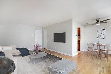 Denver apartment for rent - a living room and dining room with a table and a television