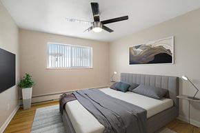 Denver apartment for rent - a bedroom with a bed and a ceiling fan