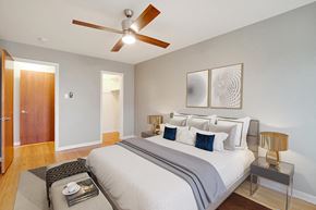 Denver apartment for rent - a bedroom with a bed and a ceiling fan