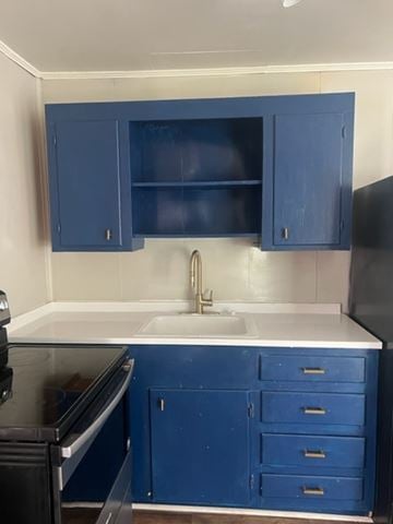 Hattiesburg apartment for rent - A kitchen with blue cabinets and a black oven.