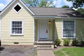 Hattiesburg apartment for rent - A small yellow house with a white door and windows.