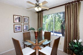 Santa Clarita apartment for rent - a dining room with a glass table and chairs and a ceiling fan