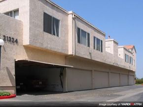 Santa Clarita apartment for rent - a large white building with a car garage