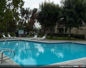 Upland apartment for rent - a blue swimming pool with white chairs