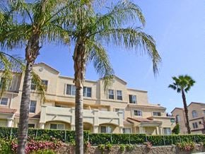 Santa Clarita apartment for rent - A row of palm trees in front of a building.