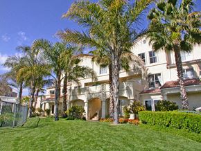 Santa Clarita apartment for rent - A large white building with a green lawn in front.