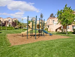 Santa Clarita apartment for rent - A playground with a slide and a swing set.